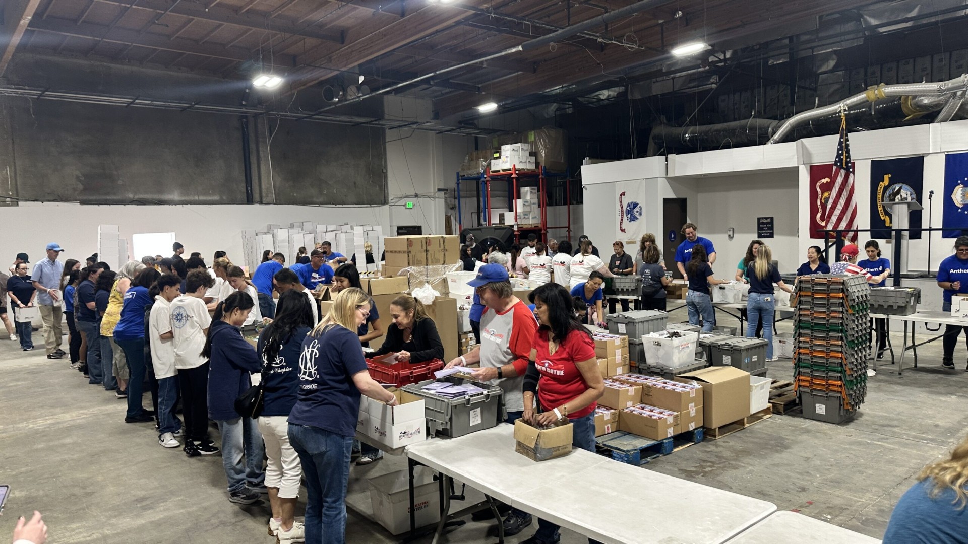 Volunteers assembling care packages at a warehouse Assembly Day