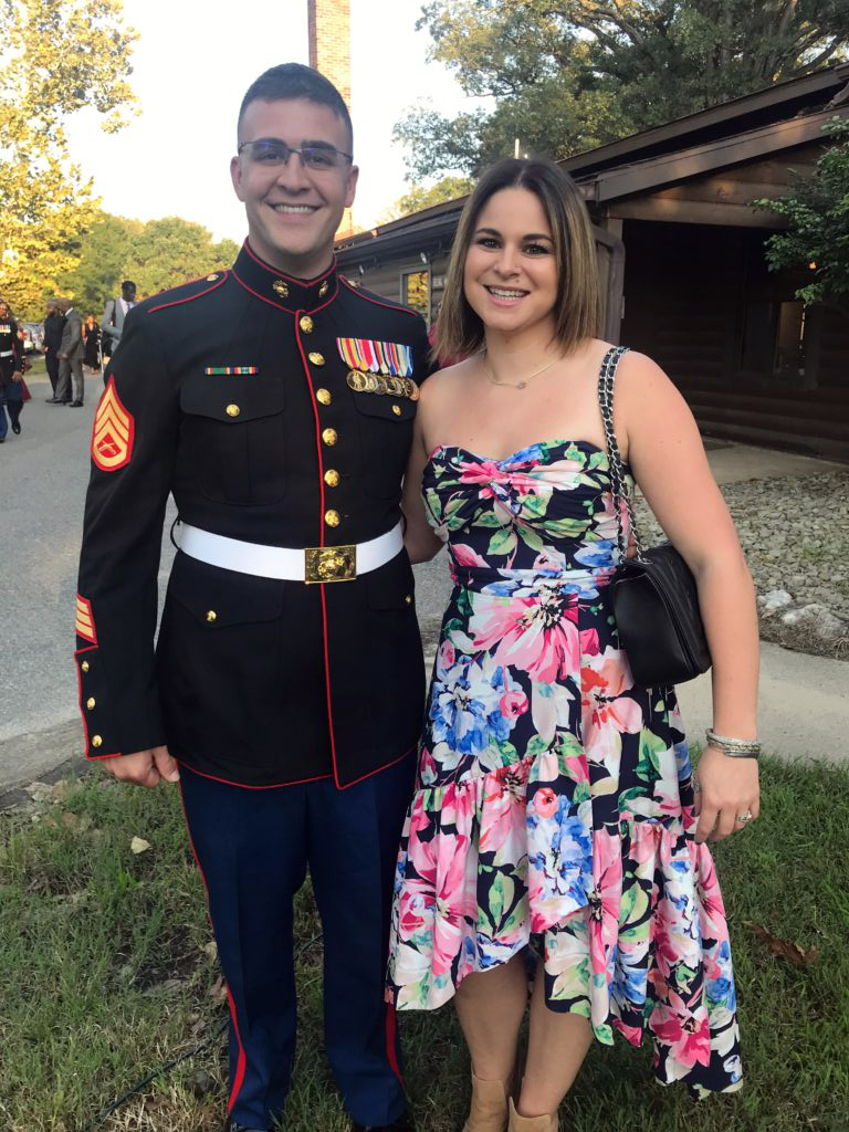 Emily Pirman posing in a dress with her husband who is wearing a US Marine Corps uniform