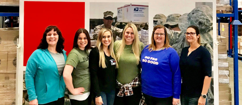 Military spouses of Operation Gratitude standing together at the Operation Gratitude warehouse