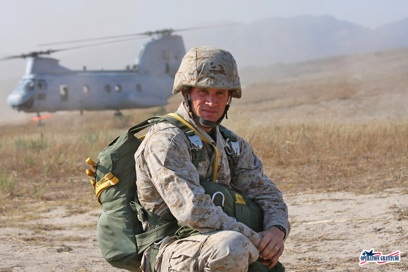 Marine in front of a helicopter