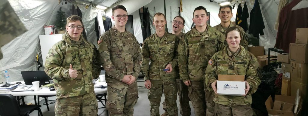 deployed service members holding care packages