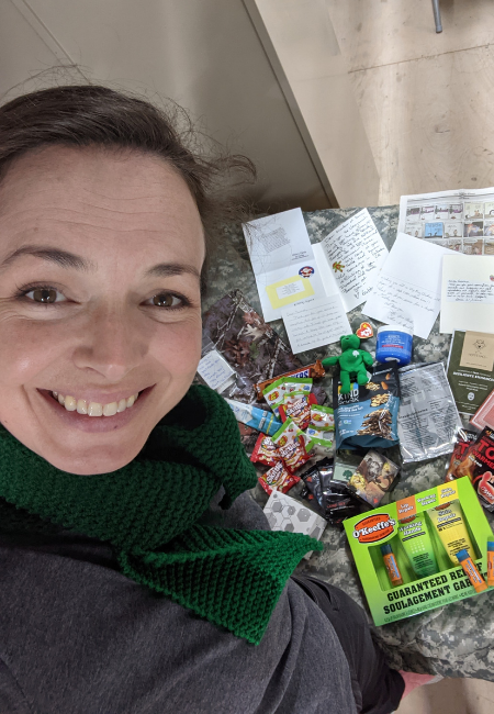 Smiling US Army Soldier with the contents of an Operation Gratitude Care Package.