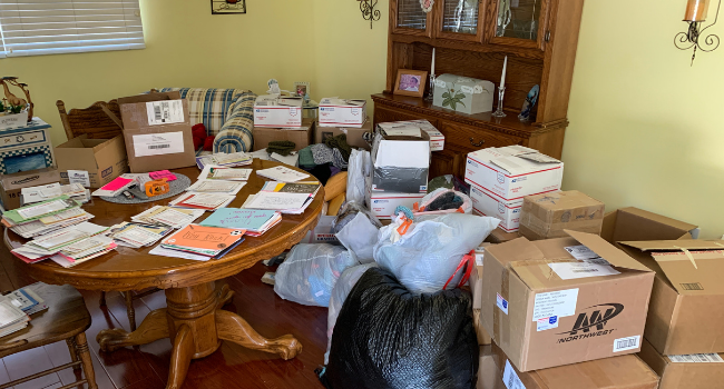 Handwritten letters for military and first responder heroes being organized on the kitchen table.