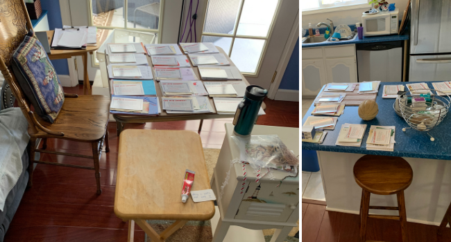 Handwritten letters for military and first responder heroes being organized on the kitchen table.