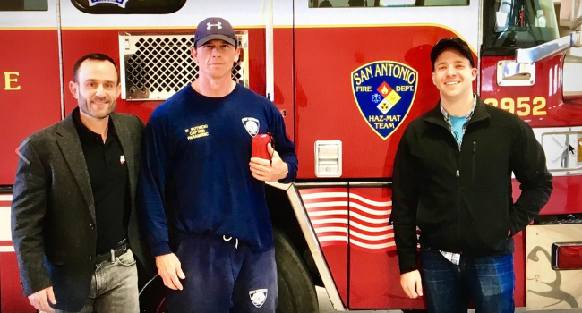 Operation Gratitude volunteers standing with a firefighter.