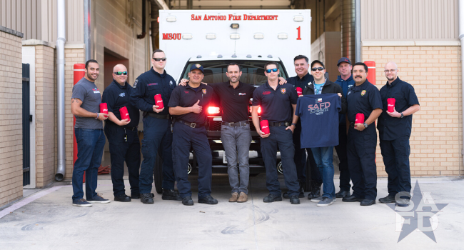 Operation Gratitude volunteers standing with firefighters.