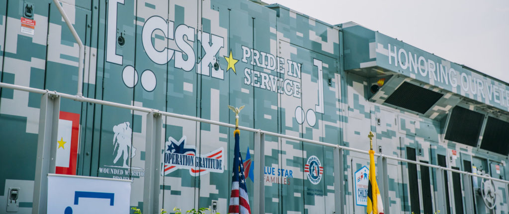 CSX train with veteran service organization nonprofit logos.