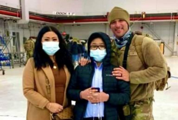 Air Force Reservist standing with his wife and son.