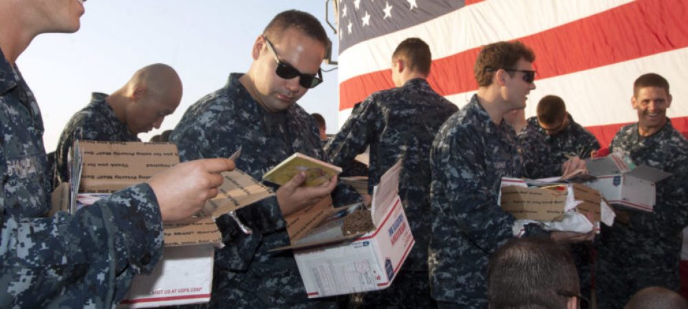 131212-N-PL185-131 GULF OF OMAN (Dec. 12, 2013) Sailors aboard the guided-missile cruiser USS Gettysburg (CG 64) open care packages during a visit from Operation Gratitude. Operation Gratitude is a non-profit, volunteer-based organization that sends care packages and letters of support to deployed individual Soldiers, Sailors, Airmen and Marines; their children; veterans; military families; first responders; Wounded Warriors and their caregivers. Gettysburg is deployed as part of the Harry S. Truman Carrier Strike Group supporting maritime security operations and theater security cooperation efforts in the U.S. 5th Fleet area of responsibility. (U.S. Navy photo by Mass Communication Specialist 3rd Class Lorenzo J. Burleson/Released)