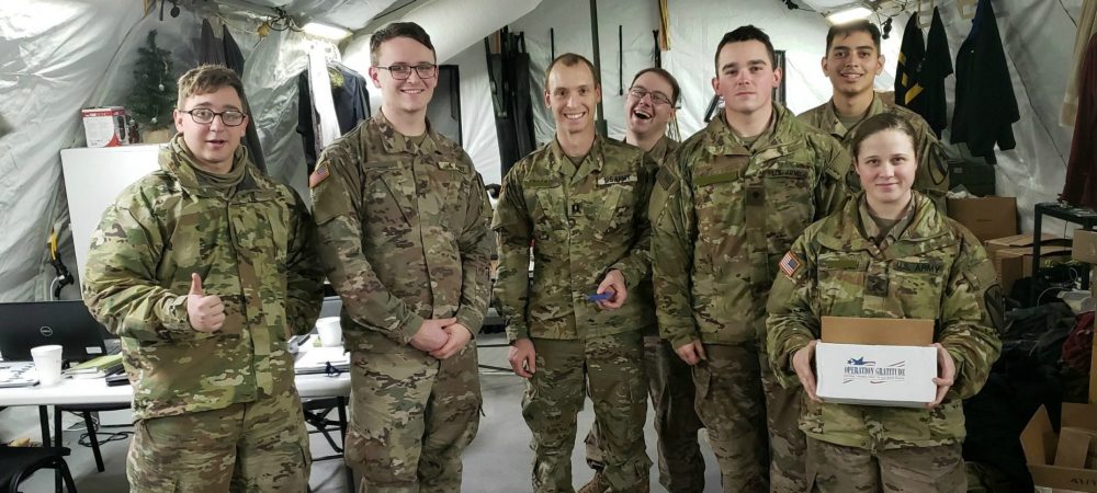 deployed service members holding care packages