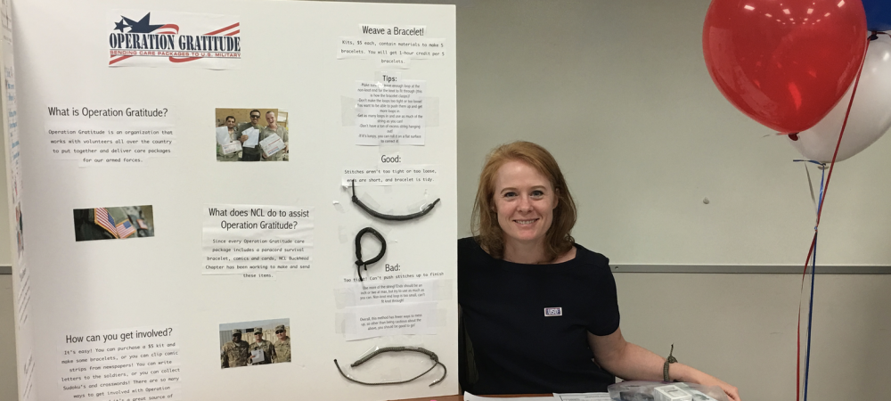 Operation Gratitude volunteer displaying table full of completed service projects.