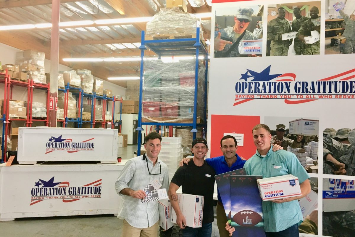 CEO Kevin Schmiegel with U.S. Marine Lance Corporals Blair, York and Grote, recipients of the three special Milestone Packages.