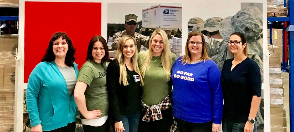 Military spouses of Operation Gratitude standing together at the Operation Gratitude warehouse