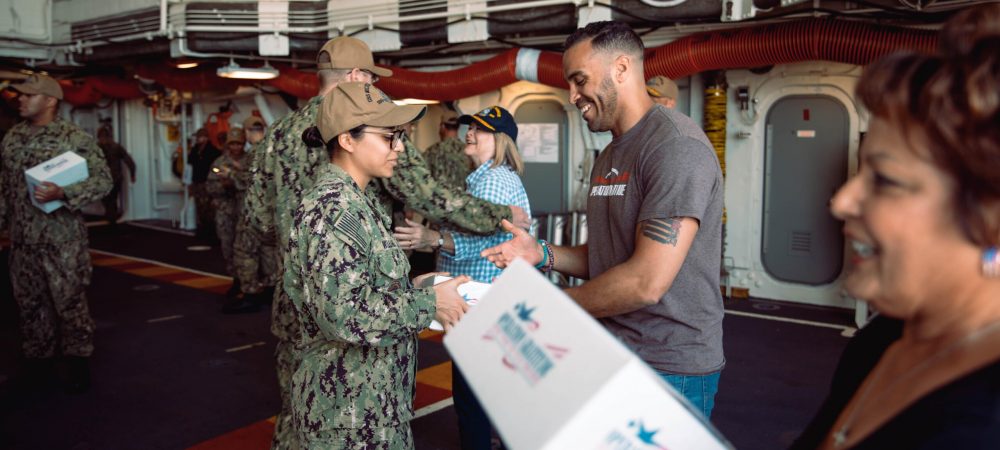 Volunteers Handing Out Care Packages_Deployed Troops_June2019