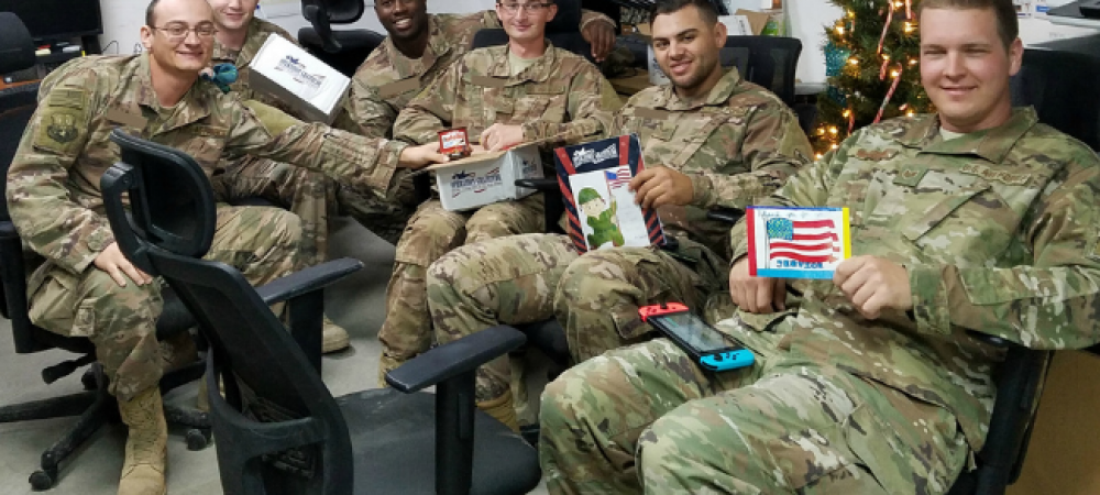 Deployed troops sitting together with handwritten letters of gratitude.