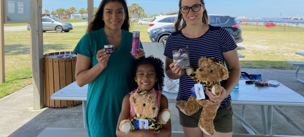 Military family members show the contents of their Operation Gratitude care package.