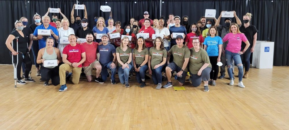 Operation Gratitude volunteers smile at the camera.